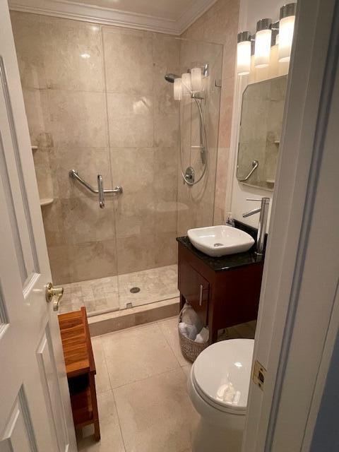 1028 SE 13th Ct, Deerfield Beach, FL 33441 - full bathroom featuring crown molding, vanity, toilet, tile patterned floors, and a stall shower