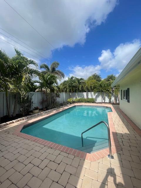 1028 SE 13th Ct, Deerfield Beach, FL 33441 - view of pool featuring a fenced in pool, a fenced backyard, and a patio area