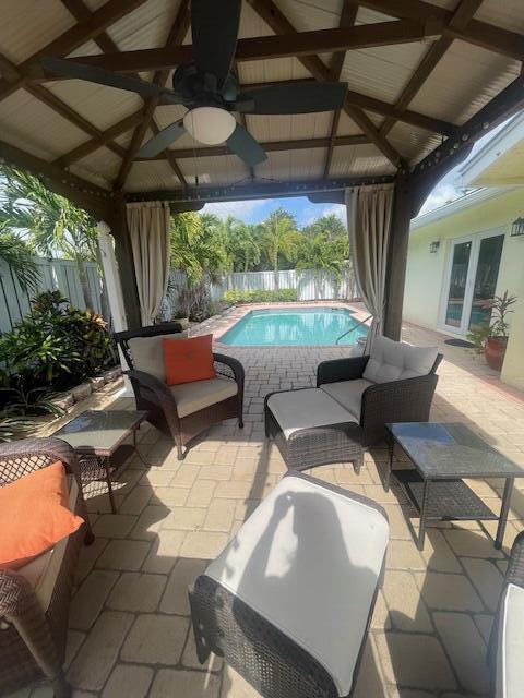 1028 SE 13th Ct, Deerfield Beach, FL 33441 - view of patio with a gazebo, a fenced in pool, and a fenced backyard