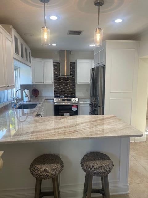1028 SE 13th Ct, Deerfield Beach, FL 33441 - kitchen featuring visible vents, freestanding refrigerator, wall chimney exhaust hood, a sink, and stainless steel electric range oven