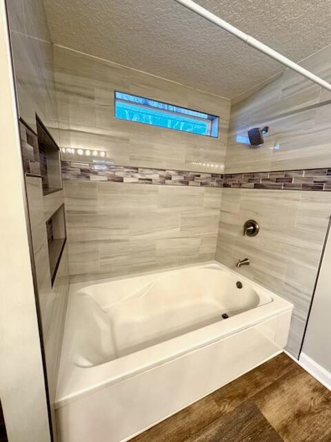 501 SE Sweet Ave, Port Saint Lucie, FL 34983 - bathroom featuring wood finished floors and a textured ceiling