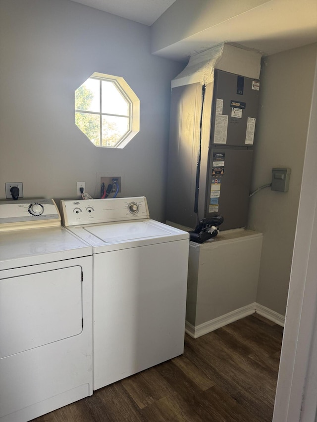 501 SE Sweet Ave, Port Saint Lucie, FL 34983 - washroom with washing machine and clothes dryer, dark wood-type flooring, and heating unit