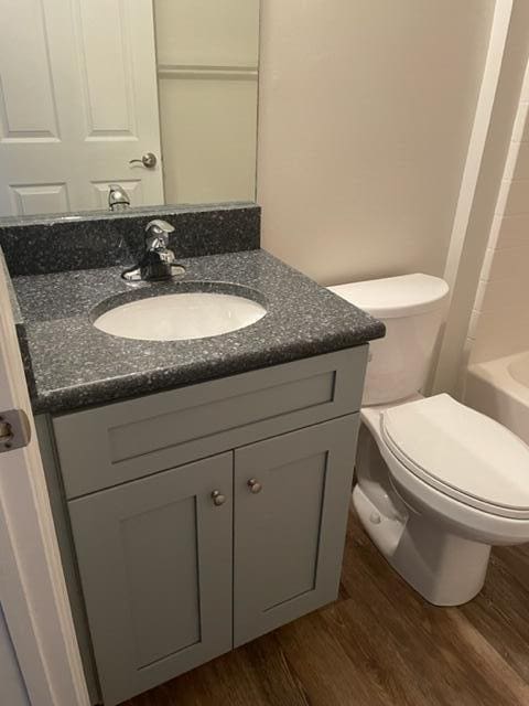 501 SE Sweet Ave, Port Saint Lucie, FL 34983 - bathroom featuring wood finished floors, vanity, and toilet