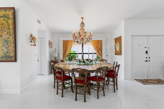 dining space with light tile patterned floors, an inviting chandelier, visible vents, and baseboards