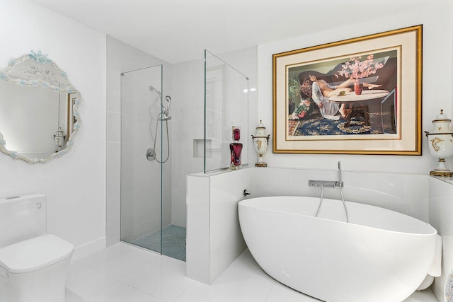 bathroom with walk in shower, a freestanding tub, and tile patterned flooring