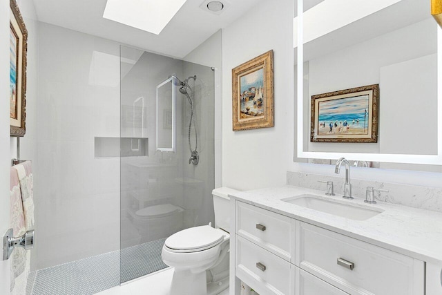 full bathroom featuring tile patterned flooring, toilet, vanity, a skylight, and tiled shower