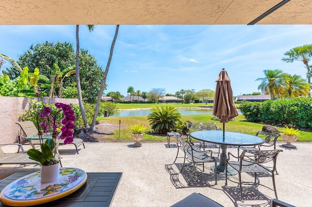 view of patio / terrace featuring outdoor dining space and a water view