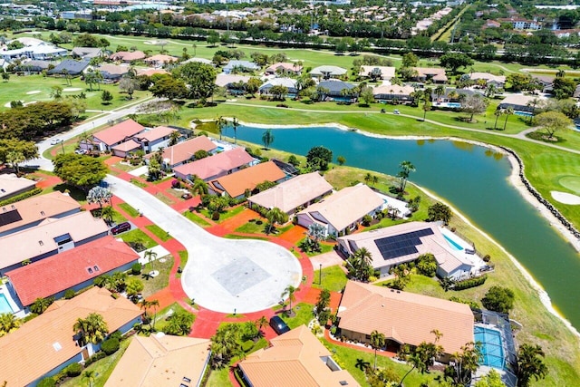 aerial view with view of golf course, a water view, and a residential view