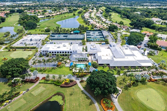 drone / aerial view with a water view and golf course view