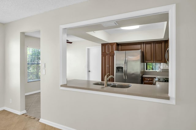 11206 Applegate Cir, Boynton Beach, FL 33437 - kitchen with a sink, light countertops, baseboards, stainless steel refrigerator with ice dispenser, and a peninsula