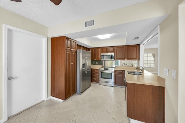 11206 Applegate Cir, Boynton Beach, FL 33437 - kitchen with brown cabinets, a sink, visible vents, stainless steel appliances, and light countertops