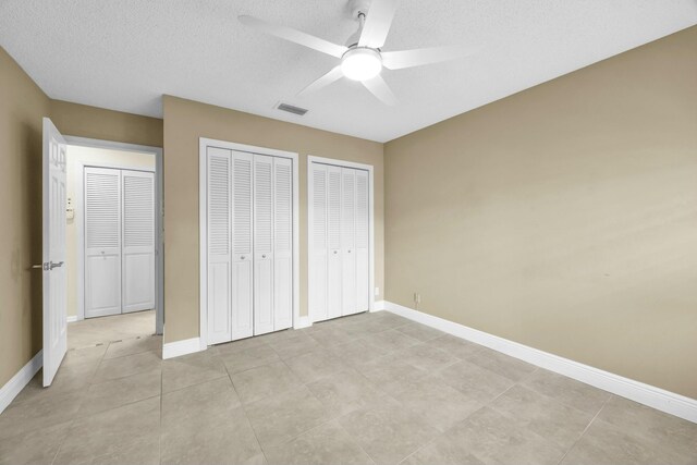 11206 Applegate Cir, Boynton Beach, FL 33437 - unfurnished bedroom featuring a textured ceiling, visible vents, multiple closets, and baseboards