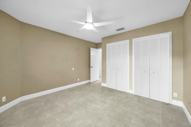 11206 Applegate Cir, Boynton Beach, FL 33437 - unfurnished bedroom featuring visible vents, a ceiling fan, light tile patterned flooring, and multiple closets