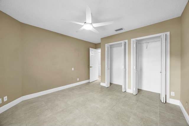 11206 Applegate Cir, Boynton Beach, FL 33437 - unfurnished bedroom with light tile patterned floors, a ceiling fan, visible vents, baseboards, and multiple closets