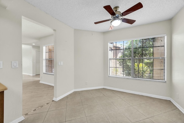 11206 Applegate Cir, Boynton Beach, FL 33437 - spare room featuring baseboards, light tile patterned floors, a ceiling fan, and a textured ceiling
