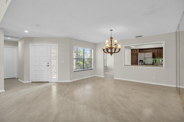 11206 Applegate Cir, Boynton Beach, FL 33437 - unfurnished living room with visible vents, light wood-style floors, baseboards, recessed lighting, and a notable chandelier