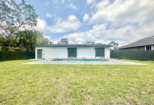 rear view of property featuring stucco siding, french doors, a patio, and fence
