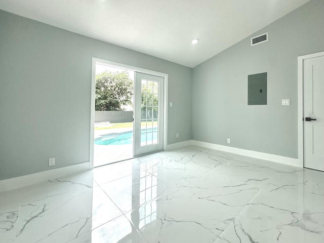 unfurnished room with vaulted ceiling, electric panel, marble finish floor, baseboards, and visible vents