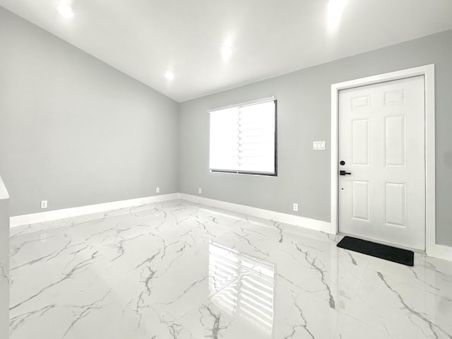 entrance foyer featuring baseboards, vaulted ceiling, marble finish floor, and recessed lighting
