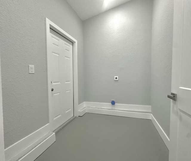 laundry area with a textured wall, laundry area, and hookup for an electric dryer