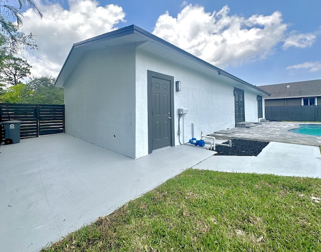 rear view of property with a patio area, a fenced backyard, a fenced in pool, and a yard