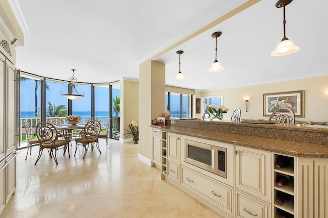 2917 S Ocean Blvd Unit 103, Highland Beach, FL 33487 - kitchen featuring stainless steel microwave, cream cabinetry, a healthy amount of sunlight, and open shelves