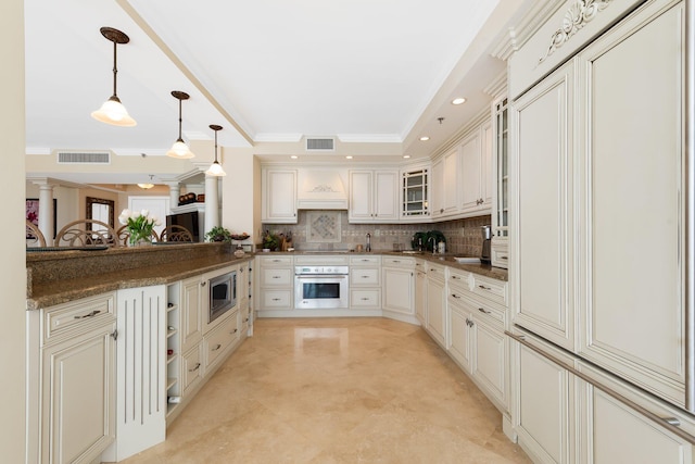 2917 S Ocean Blvd Unit 103, Highland Beach, FL 33487 - kitchen with a raised ceiling, visible vents, appliances with stainless steel finishes, and decorative backsplash