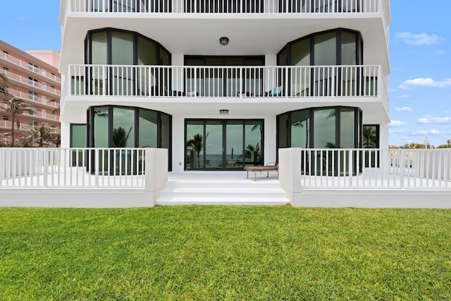 2917 S Ocean Blvd Unit 103, Highland Beach, FL 33487 - rear view of property with a lawn, a balcony, and stucco siding