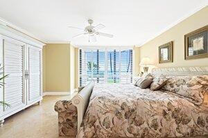 2917 S Ocean Blvd Unit 103, Highland Beach, FL 33487 - bedroom with a ceiling fan, baseboards, crown molding, and multiple windows