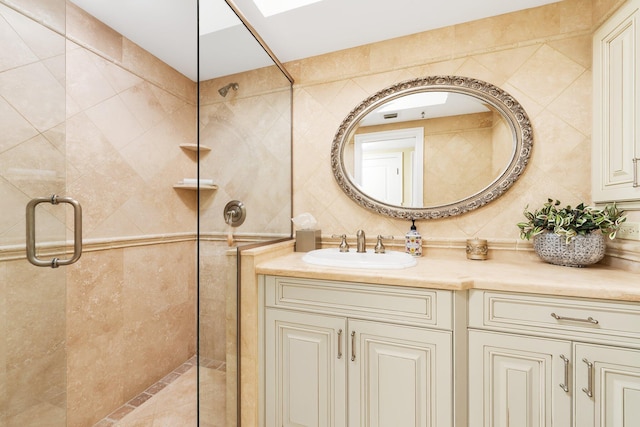 2917 S Ocean Blvd Unit 103, Highland Beach, FL 33487 - full bathroom with a shower stall, backsplash, vanity, tile walls, and a skylight