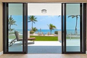 2917 S Ocean Blvd Unit 103, Highland Beach, FL 33487 - doorway to outside featuring a healthy amount of sunlight and a water view