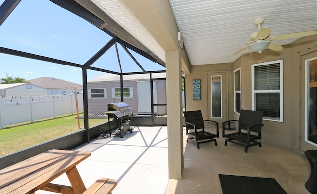 sunroom featuring plenty of natural light and ceiling fan