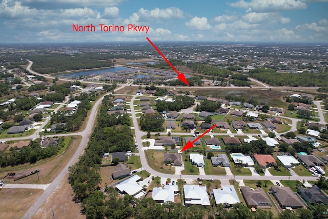 drone / aerial view featuring a residential view and a water view