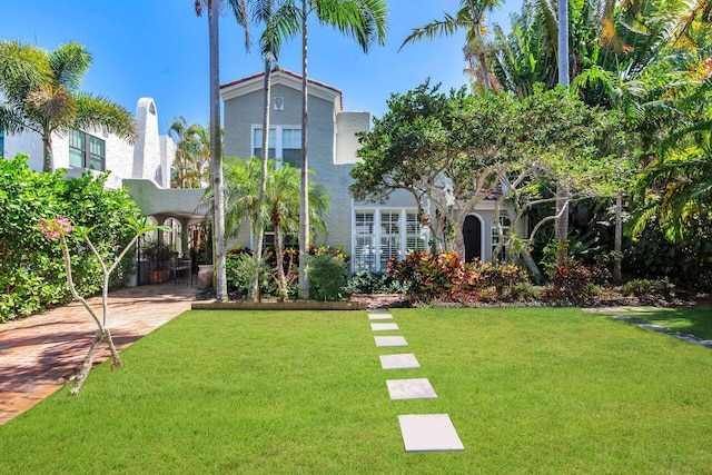 138 Greymon Dr, West Palm Beach, FL 33405 - back of house with stucco siding and a yard