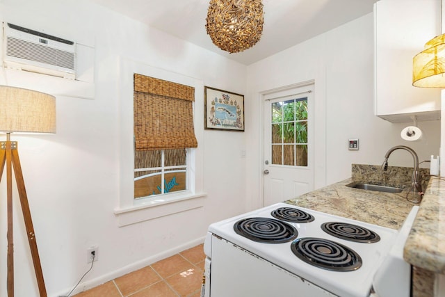 138 Greymon Dr, West Palm Beach, FL 33405 - kitchen featuring baseboards, a wall mounted air conditioner, white electric range oven, a sink, and light tile patterned floors