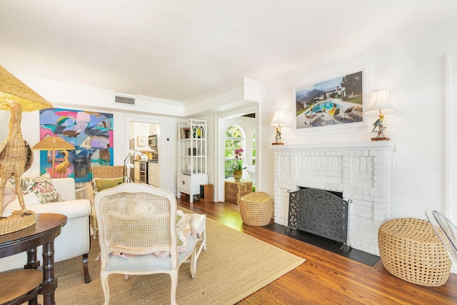138 Greymon Dr, West Palm Beach, FL 33405 - living room featuring visible vents, ornamental molding, wood finished floors, and a fireplace