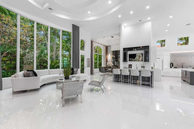 5784 Vintage Oaks Cir, Delray Beach, FL 33484 - living area with a towering ceiling, light tile patterned flooring, recessed lighting, and a healthy amount of sunlight