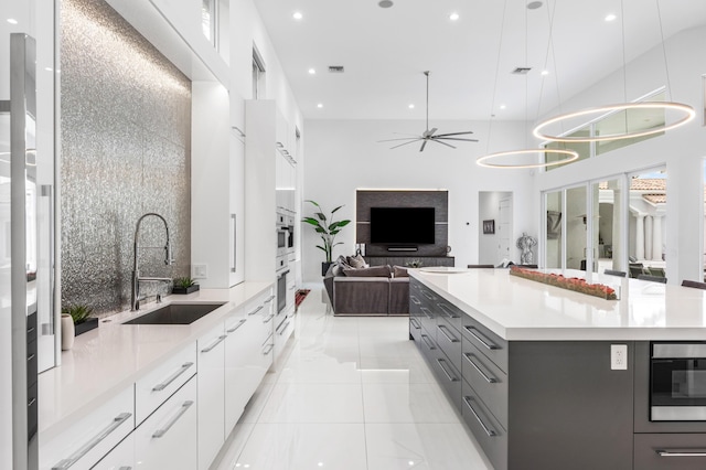 5784 Vintage Oaks Cir, Delray Beach, FL 33484 - kitchen featuring gray cabinets, light countertops, ceiling fan, a sink, and modern cabinets
