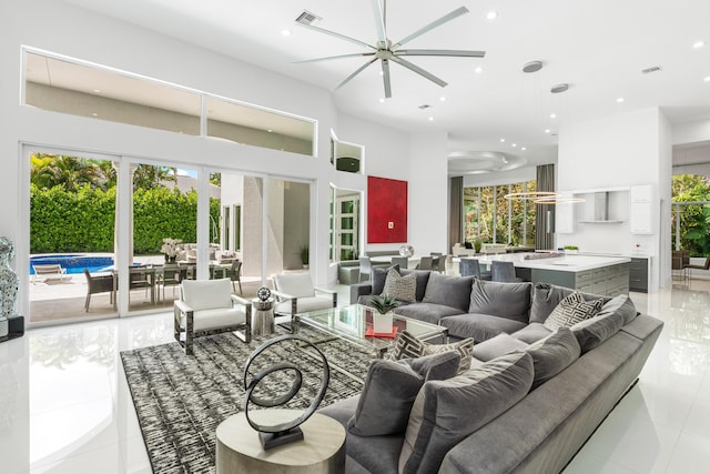 5784 Vintage Oaks Cir, Delray Beach, FL 33484 - living room featuring recessed lighting, visible vents, a ceiling fan, light tile patterned flooring, and a towering ceiling