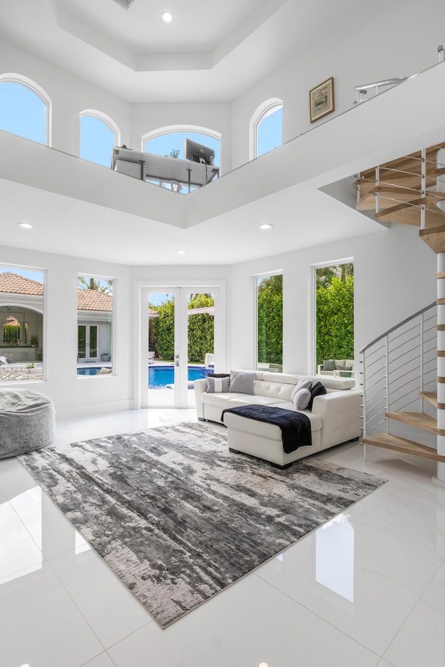 5784 Vintage Oaks Cir, Delray Beach, FL 33484 - living room featuring recessed lighting, tile patterned floors, french doors, a high ceiling, and stairs