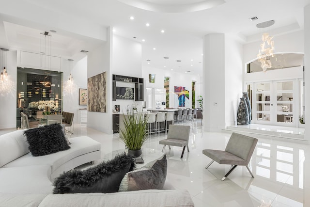 5784 Vintage Oaks Cir, Delray Beach, FL 33484 - living area with a towering ceiling, recessed lighting, a tray ceiling, and a notable chandelier