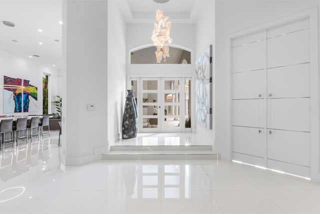 5784 Vintage Oaks Cir, Delray Beach, FL 33484 - tiled entryway featuring recessed lighting, a high ceiling, an inviting chandelier, and baseboards