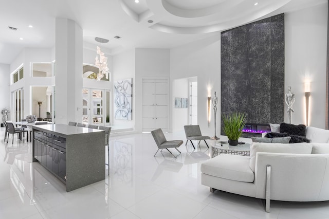 5784 Vintage Oaks Cir, Delray Beach, FL 33484 - living room featuring visible vents, light tile patterned flooring, recessed lighting, a notable chandelier, and a high ceiling
