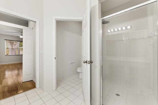 4155 NW 1st Ct, Delray Beach, FL 33445 - full bathroom featuring a shower stall, a ceiling fan, toilet, and baseboards