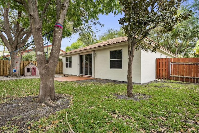 4155 NW 1st Ct, Delray Beach, FL 33445 - rear view of property with stucco siding, a tile roof, and a patio area