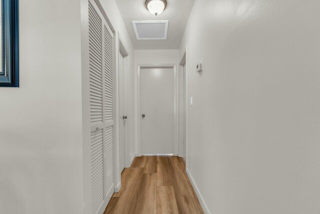 living area featuring baseboards and wood finished floors