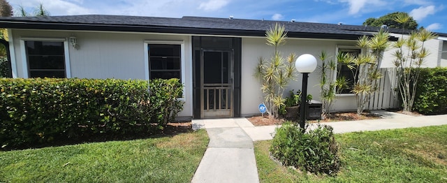 4389 Willow Pond Cir, West Palm Beach, FL 33417 - doorway to property featuring a lawn and fence