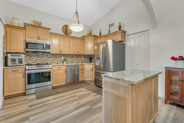 kitchen featuring light wood-style floors, decorative backsplash, light brown cabinetry, and stainless steel appliances