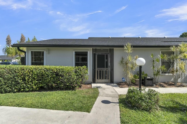 4389 Willow Pond Cir, West Palm Beach, FL 33417 - view of front of property featuring central AC unit, roof with shingles, and stucco siding