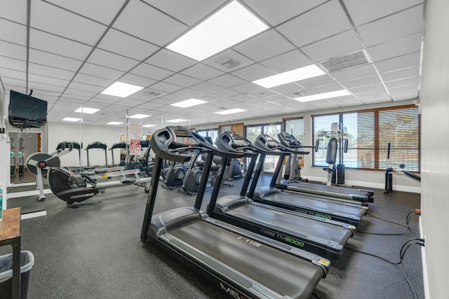 exercise room with visible vents, baseboards, and a drop ceiling